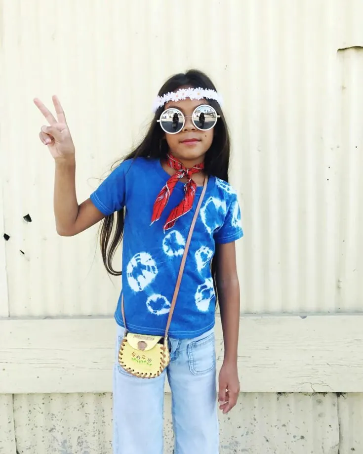 Groove back in time to the 60s with this funky flower girl costume. Embrace the peace and love emitting the flower power vibes as your kid transforms into a retro flower child this Halloween!