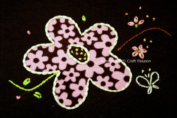 Free downloadable embroidery pattern for couching flower applique. Showing step by step picture on how to sew the couching stitch.
