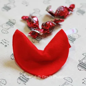 Insert candy into fortune cookie