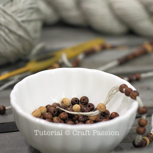 threading beads into yarn