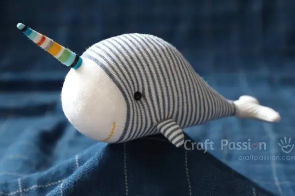 Adorable Sock Narwhal stuffed animal, Nadir, sewed from a sock! Grab the free pattern template & step-by-step Instructions to sew it.