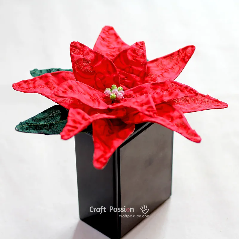 Learn how to make a fabric flower with this simple poinsettia tutorial. Use fabric and wire to create festive Christmas decorations or DIY bouquets.