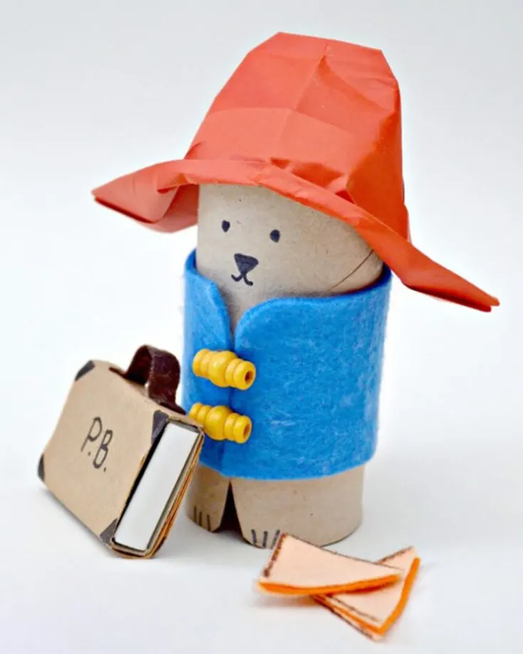 Take a look at this adorable little Paddington Bear craft out of a cardboard tube. With his blue felt vest, red origami hat, and cardboard suitcase, this craft is perfect for all Paddington Bear fans of all ages.