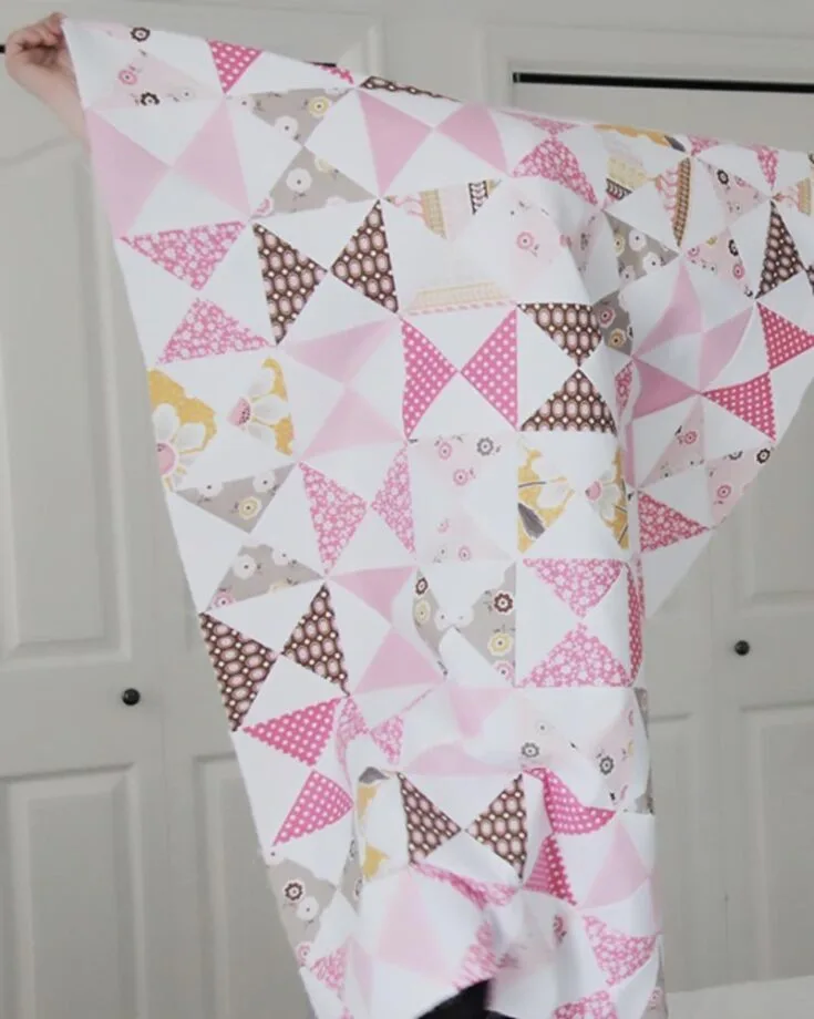 Can&rsquo;t get enough of baby pink quilt patterns for beginners? This Pink Classic Quilt has a written tutorial to guide you into making a timeless piece that combines soft pink and white squares with hourglass blocks arranged in a classic, soothing, and visually pleasing pattern. This pattern yields a 32&rdquo; x 41&rdquo; sized quilt.