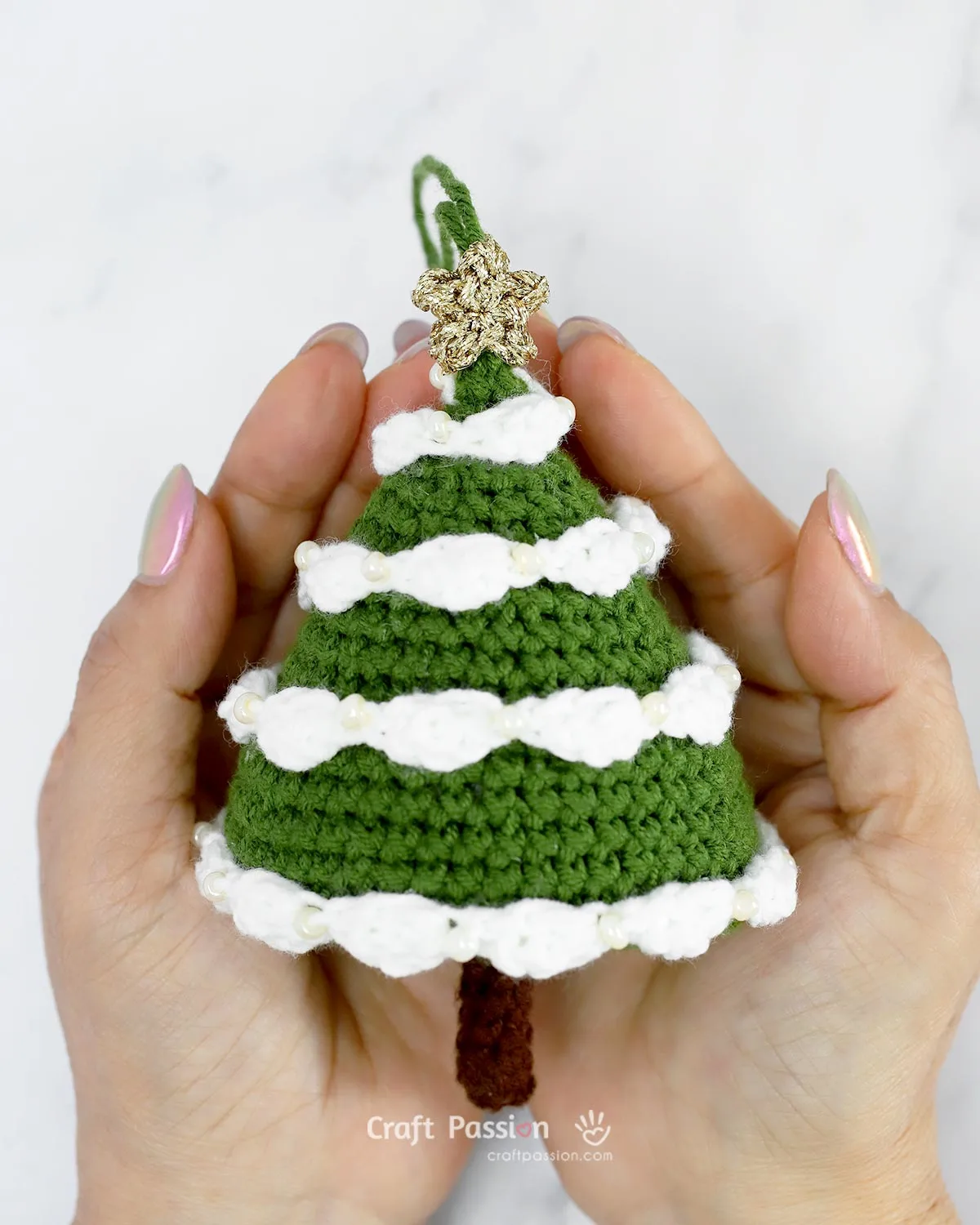 Beginner-friendly free amigurumi Christmas tree crochet pattern with step-by-step photos. Make a festive tree with snow garland and star topper!