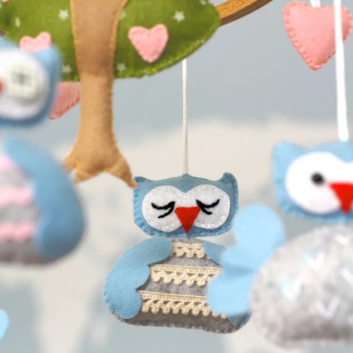 Create an adorable DIY baby mobile with our free sewing pattern featuring cute owl characters & a lovely tree design. Perfect nursery decor & baby shower gift!