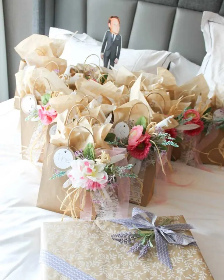 These bachelorette party gift bags are a stylish and fun treat! Decorated with lace ribbons, faux flowers, and name tags, fill them with goodies your friends will love. Think favorite snacks, self-care items, or even fun keepsakes.