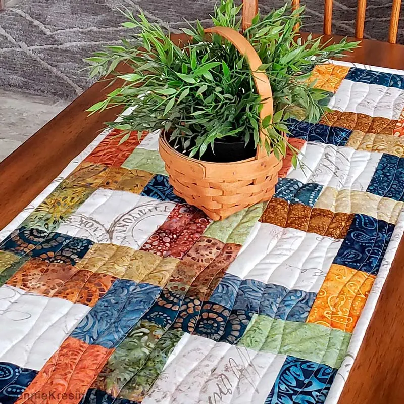 If you're looking for a fast and easy quilt runner project, this design is a must-have on your list. This runner is made with a charm pack and some additional fabric for the center squares. It's also scrap-friendly.&nbsp; Table runner size: 16" x 32"&nbsp;