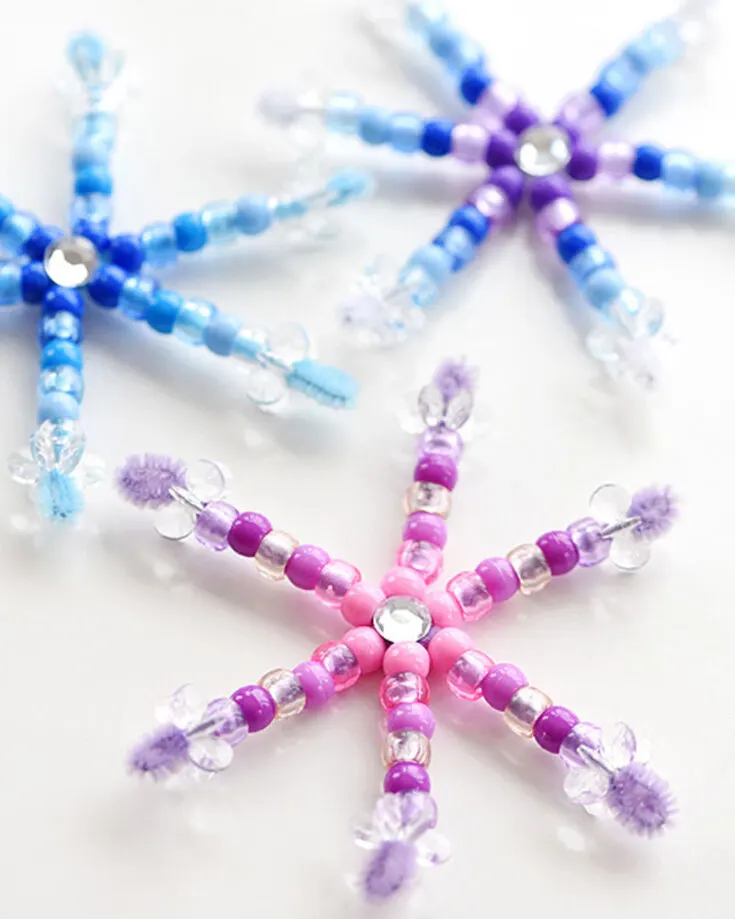 Decorate your home by crafting these simple snowflakes made from pipe cleaners and beads for the Christmas holidays. Hang them in windows, your tree, or string them together to create a sparkling garland.