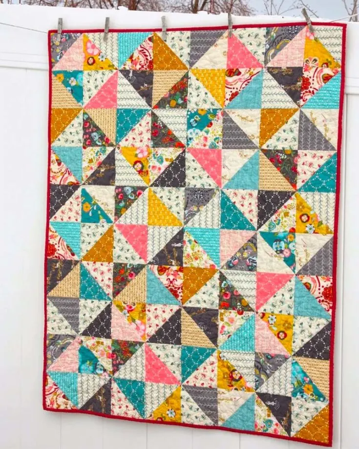 Sew yourself this 40? x 50? crib quilt if you've got a pretty plethora of fabrics you'd like to showcase! It's comprised of half square triangles and you could use charm packs too!