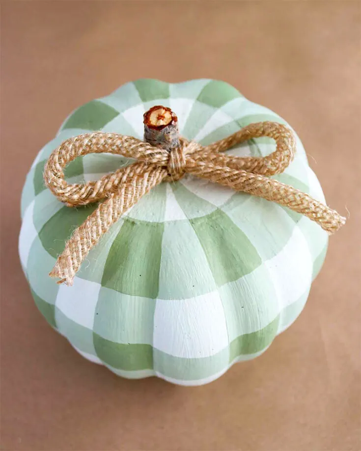 This buffalo plaid pumpkin is great for customizing and will fit almost every fall d&eacute;cor! Chalk paint is used to cover the foam pumpkin. It's a super easy pumpkin painting idea.