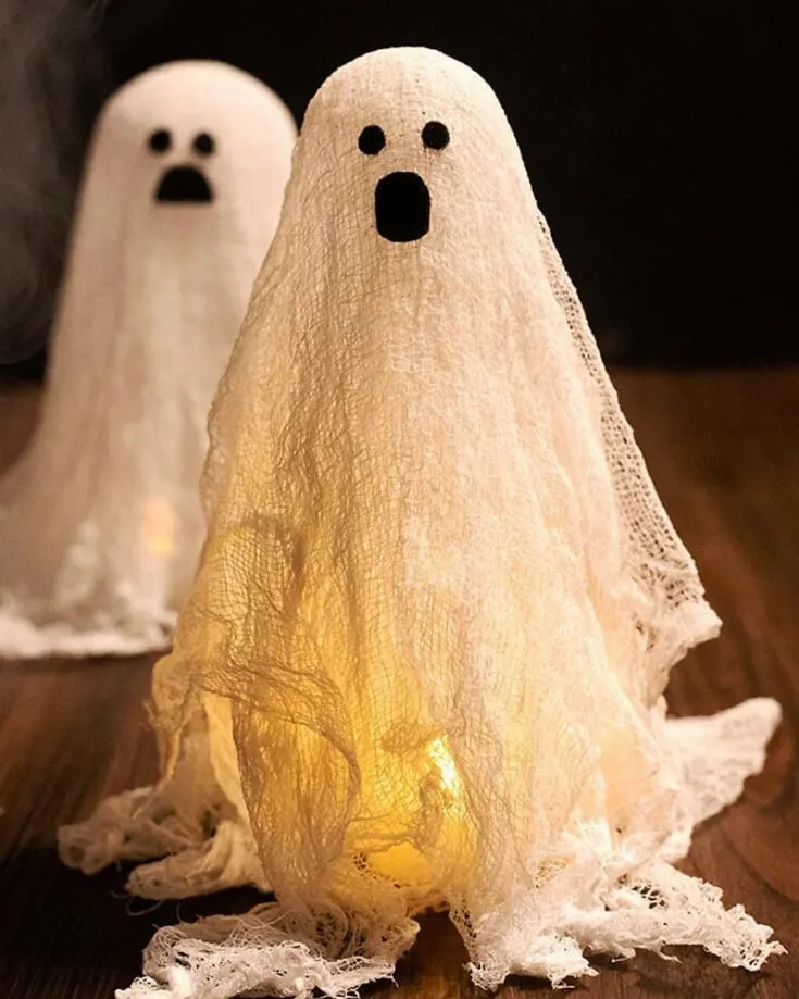 Craft a playful yet scary Cheesecloth Ghost that screams joy to your neighbors or onlookers. You and your family can enjoy this captivating and engaging activity where you watch as the ghosts come to life by following this tutorial. Give it a go!
