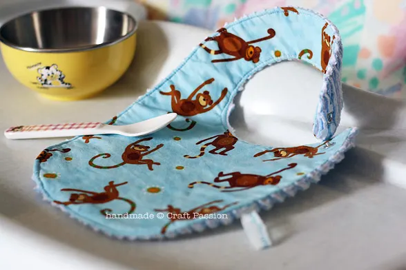 Free pattern & tutorial for making chenille fabric and sewing it into a bib. This bib sewing pattern is a quick project, perfect for a baby shower gift.