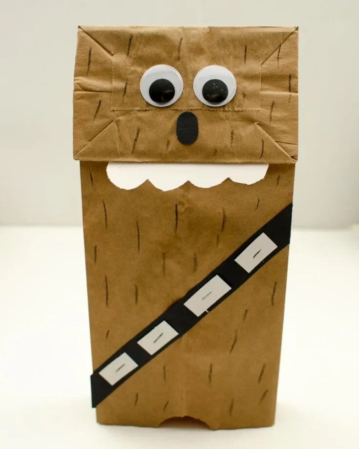Like the Yoda craft, the primary materials are a paper bag, decorative materials, and glue. It is super easy as it has a similar template. Let's roar with the Wookiees!