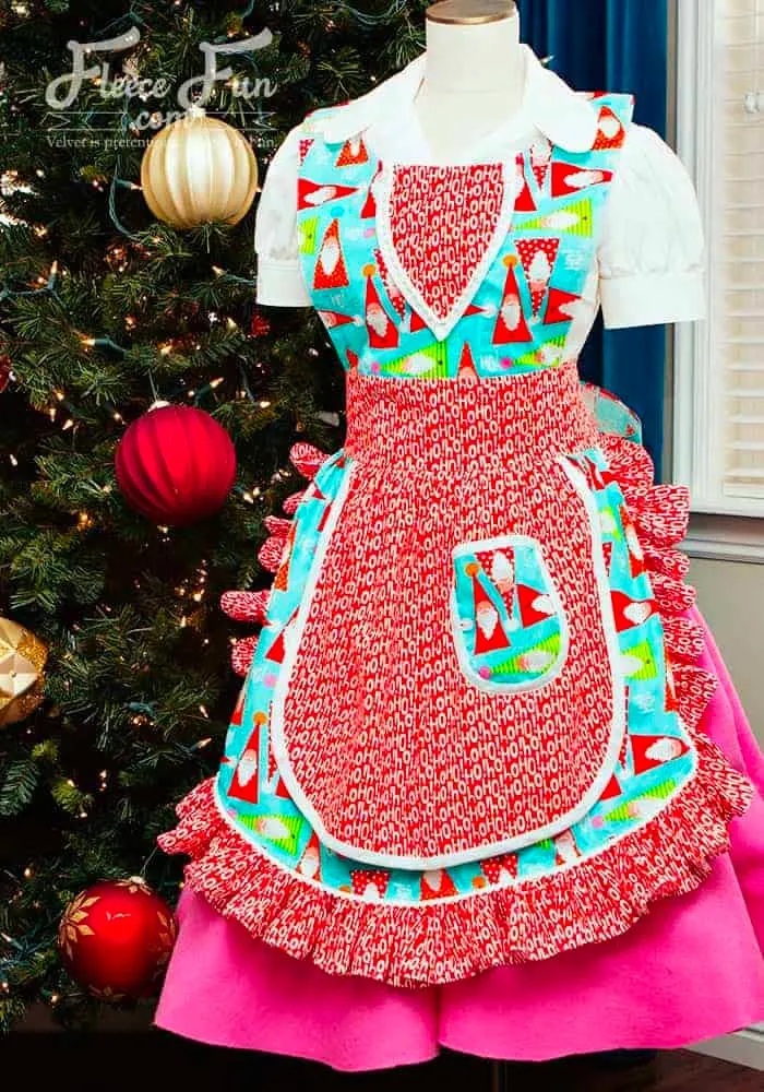 Tis the season to sew yourself a festive apron! It's got double-sided bodice tape lining up the bodice piece and circle skirt while a ruffled hem runs along the bottom skirt, reminiscent of the 1950s vintage aprons. A cute button holds the neck-straps together.