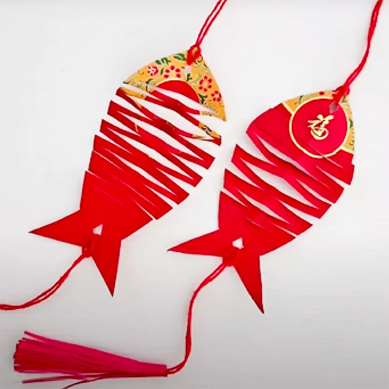 Create a unique and fun fish ornament for Chinese New Year with this simple craft! The clever slice cutting allows the fish to stretch and lengthen when pulled, adding a playful touch. It&rsquo;s a festive and symbolic decoration, perfect for celebrating abundance and prosperity!