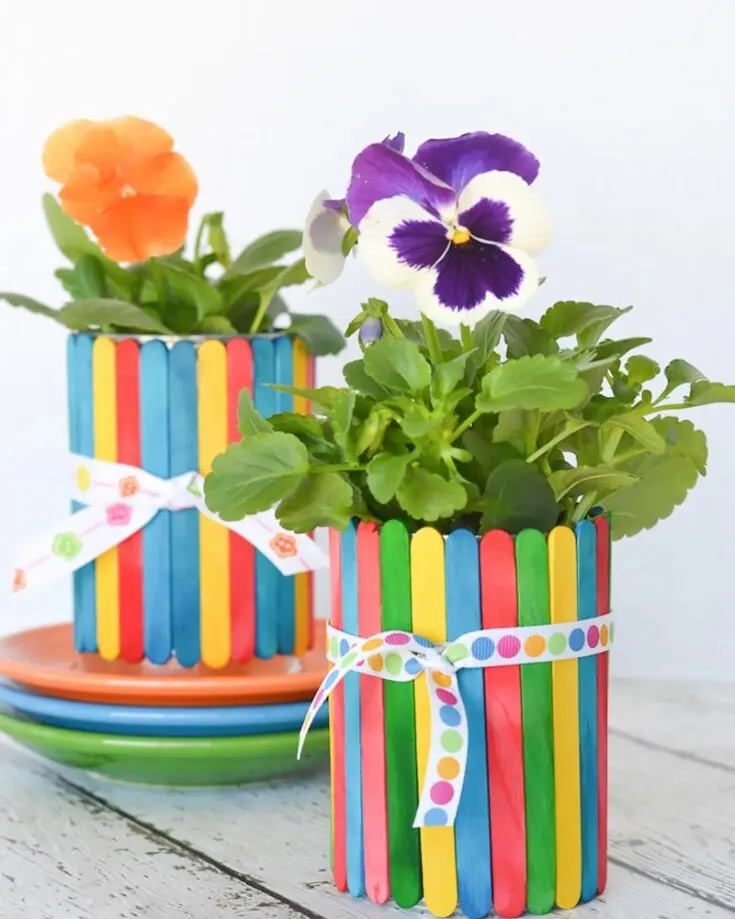 Speaking of a colorful garden, check out this gorgeous design for Earth Day crafts! Popsicle sticks can be easily collected from ice cream, and you can refurbish them by adding funky colors. This playful DIY turns ordinary pots into a vibrant masterpiece. Watch as your flowers grow in delight because we all need a colorful environment to flourish!