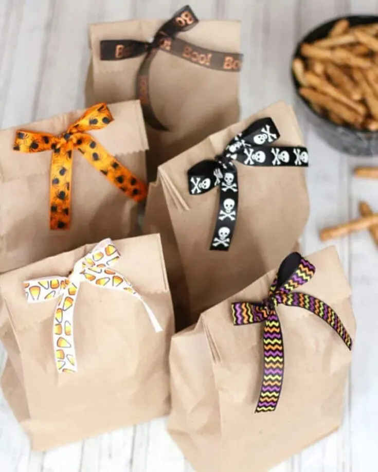These crafty little goodie bags are all dressed up with Halloween themed ribbons, making them perfect for spooky surprises! The best part? You can easily switch out the ribbons for any occasion, giving them a fresh twist for any celebration you have in mind!