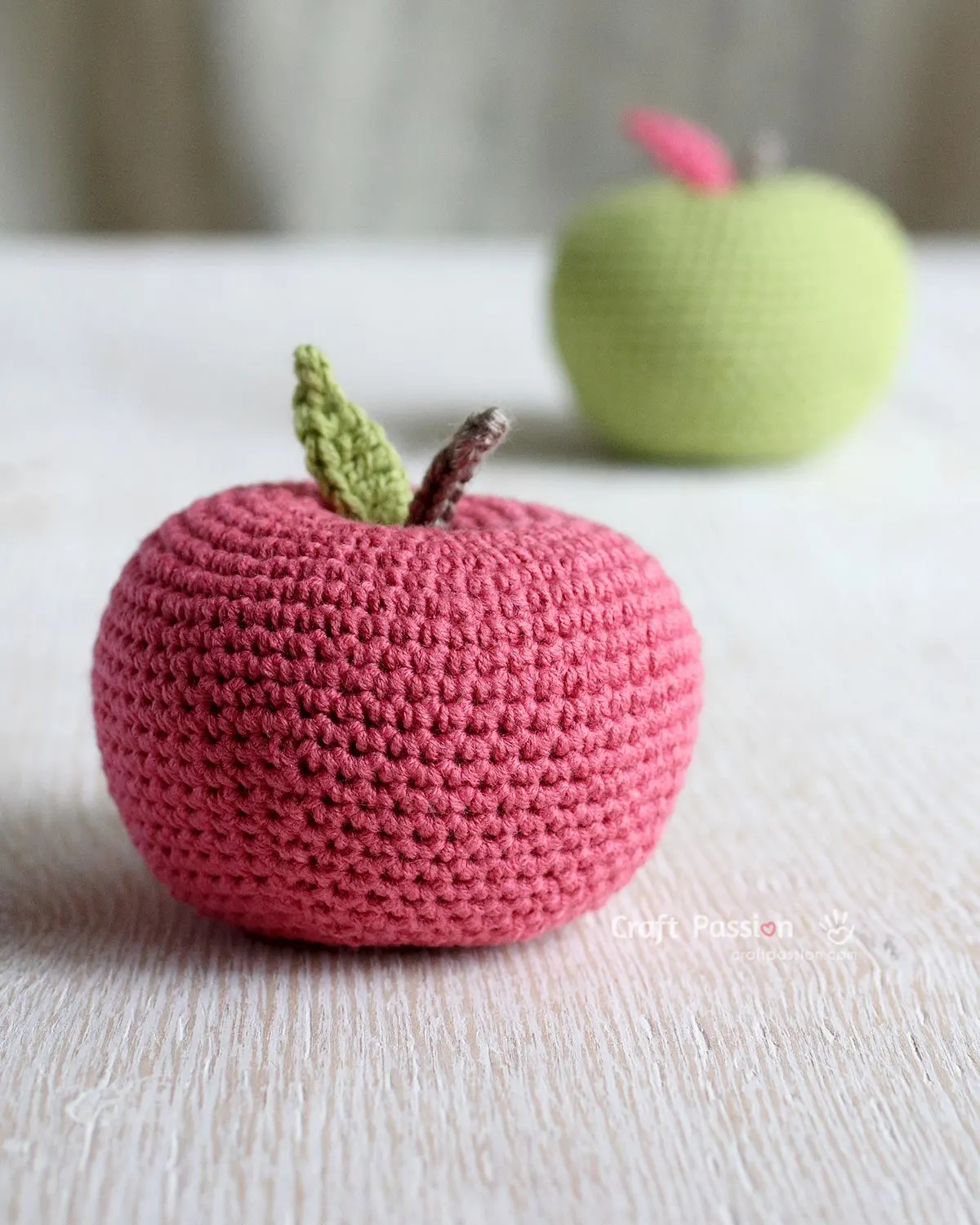 Free Crochet Apple Amigurumi Pattern that looks like a real apple. Use a different weight of yarns & hooks to crochet various sizes of apple. 
Add some characters to the crochet apple with
1. add a worm with its head sticking out from the apple. 
2. Add eyes and a smiling mouth with a rosy cheek for a kawaii look. 
3. Use rainbow-colored yarn to create a rainbow apple.