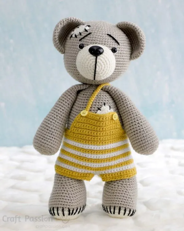 free crochet teddy bear pattern wearing an overall dungarees.