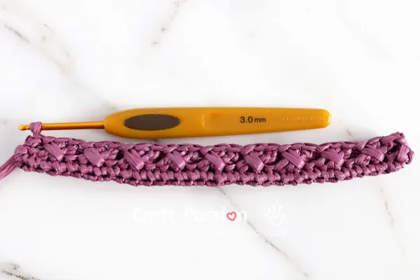 first round of cable stitch on a small crochet crossbody bag