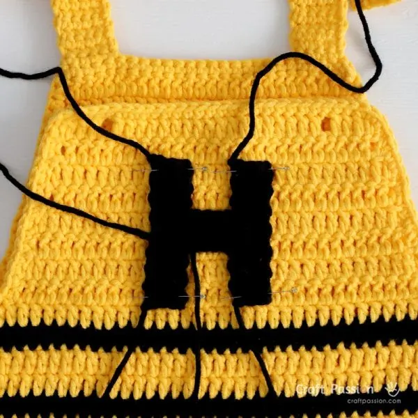 Add a letter &ldquo;H&rdquo; applique for a charming personalized detail and completes the playful Honey Bee theme.