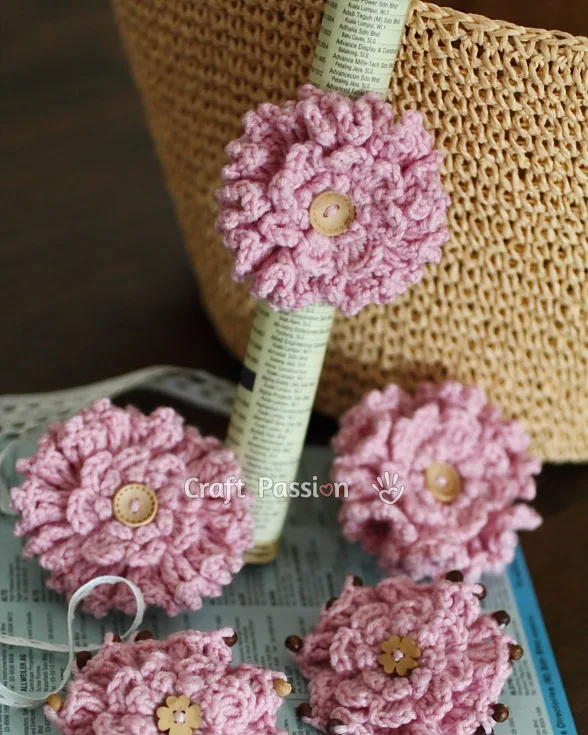 Free pattern to make a beautiful crochet ruffled flower from stashed yarn, perfect as a handmade gift like a brooch or hair tie or embellishment.