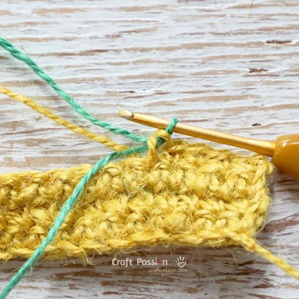 add green yarn into the crochet for the colorwork of shamrock coaster
