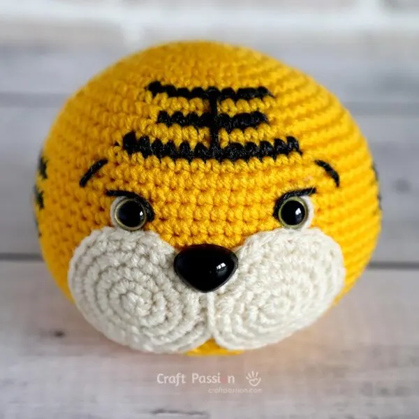 crochet tiger's head after attaching muzzle and markings