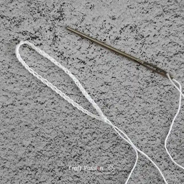 crochet a hanging loop holder and leave long tail for sewing the mesh fabirc into loofah