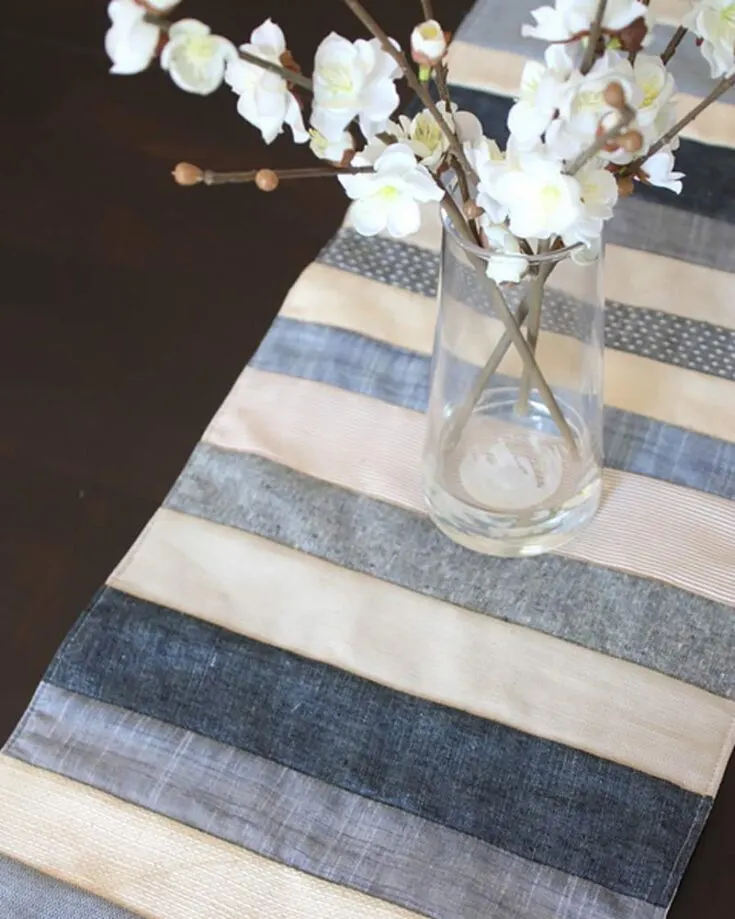 Make this wonderful quilt pattern that features denim and textures! It's a quilt-as-you-go design that includes fabric such as denim, chambrays, and linens. It's a fun way to play with shades and textures rather than a dramatic color contrast for a calm and soothing vibe. Though this beginner-level project is not a tutorial, you can find the Original Quilt Tutorial here.&nbsp; Table runner size: Adjustable