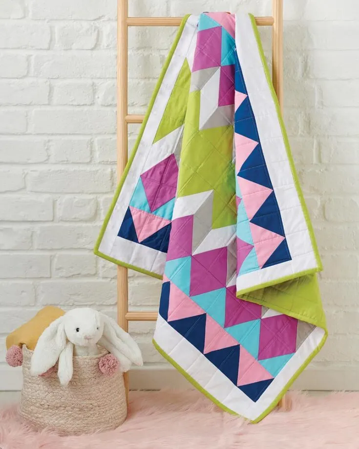 Want to learn how to mix and match half-rectangle triangles to make a replica of this graphic quilt design? Click the link below and follow the step-by-step guide to create a geometric color pop finish to your quilt! The finished size is 38&rdquo; x 36&rdquo;.