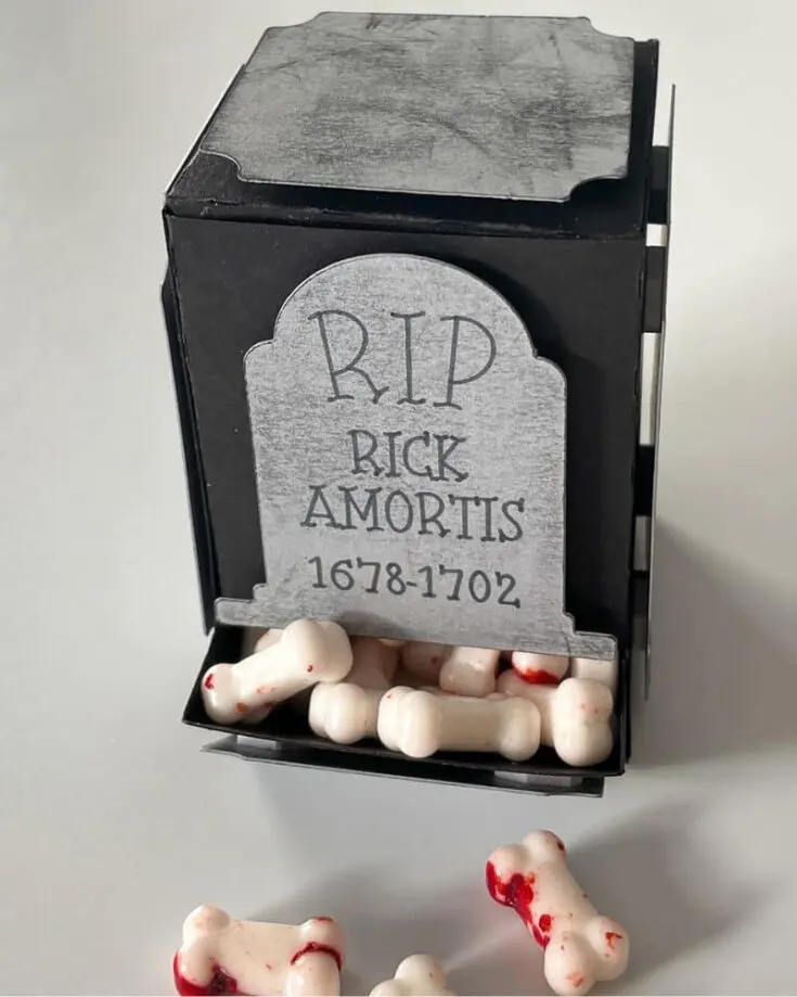 How excellent is this spooky candy dispenser with bloody candy bones? You can find the SVG file for the dispenser box on Etsy, and if you don&rsquo;t have a Cricut, just cut out the template manually. Use a black ink pad to smudge the edges and the top to give the gravestone a creepy, old look.