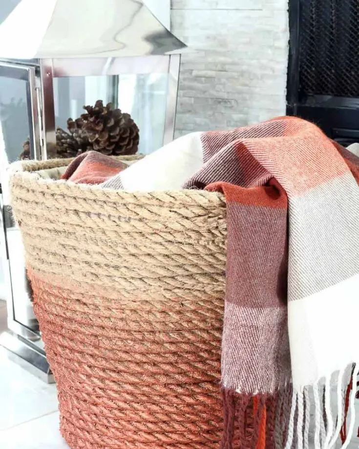 With an ordinary plastic laundry basket and some rope, you can craft yourself a cozy throw basket for your living room blankets for days when you want to cuddle under a warm blanket in front of the fireplace. Or you can use it as an upgraded basket for your laundry.