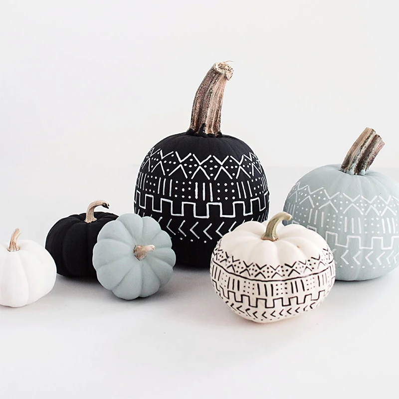Here is another one of those creative pumpkin painting ideas for adults. If you're a fan of precision, symmetry, and geometry, this mud-cloth-inspired pumpkin is for you.
