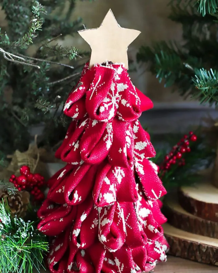 Here is a cute little way to decorate the base of your Christmas tree. These miniature Christmas Trees are fluffy and cute but serve a good purpose. Make that barren base colorful and bright!