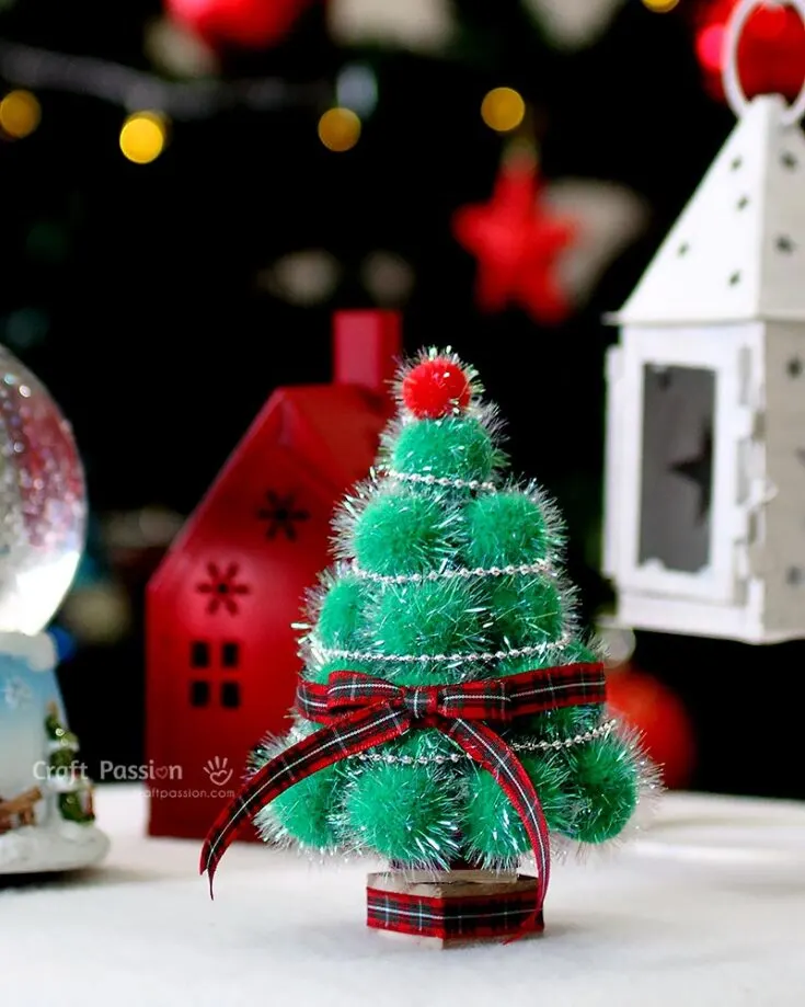 A miniature pom-pom Christmas tree is a delightful DIY that&rsquo;s perfect for adding a festive touch anywhere! Place it on a windowsill, use it as a centerpiece for your holiday dinner, or even add it to your bookshelf for a pop of holiday cheer. Cute, easy to make, and bursting with Christmas magic!