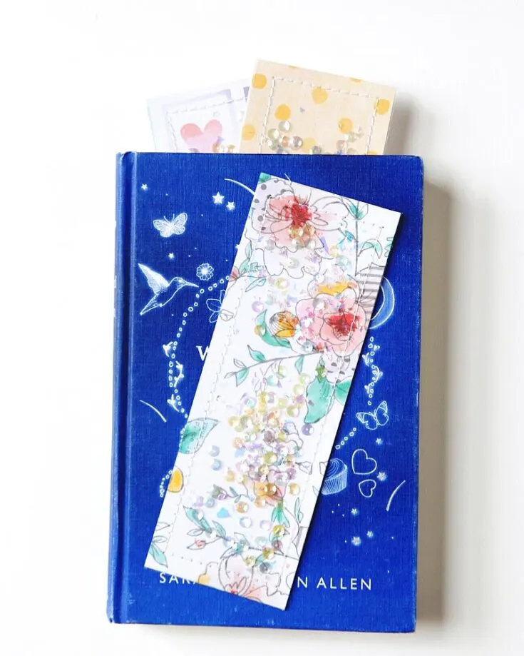 Shake up your comfort zone with this delightful DIY Shaker Pocket Bookmark project! It's an exciting and easy craft that mixes colored paper scraps with sequins for a bling. It also makes for a perfect gift for young female readers!