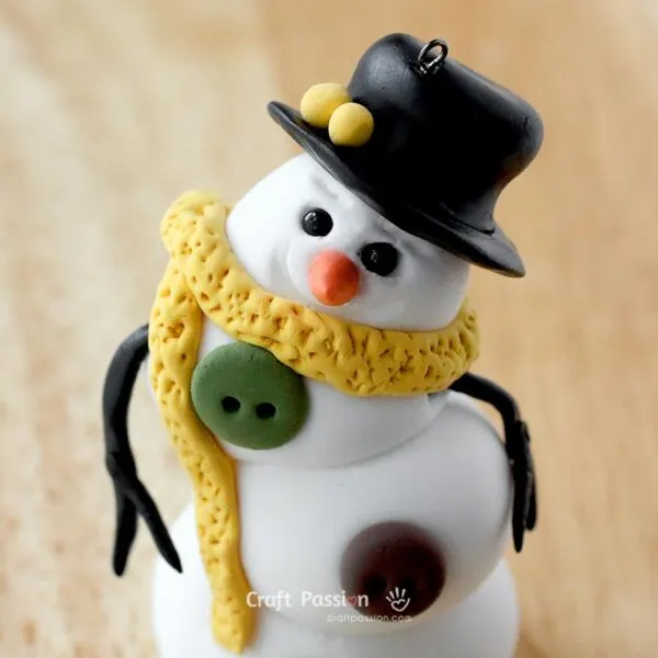 add accessories to the diy snowman ornament made from clay