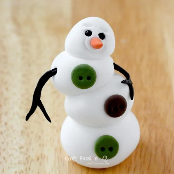Roll two long sticks and two shorter sticks from brown clay.

Attach the shorter sticks to the long ones to create branch-like arms.

Lightly press the pieces together to hold them in place.

Poke small holes at the sides of the snowman&rsquo;s body ("shoulders") and insert the arms.