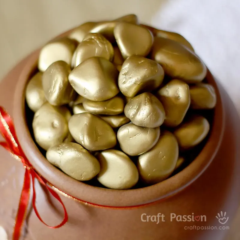 Make this easy faux gold nuggets decor to bring good luck to you. All you need are pebbles and gold spray paint. A pot of gold nuggets is a pot of good luck!