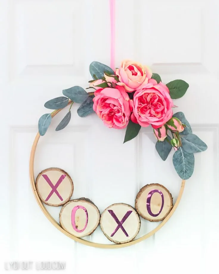 DIY this Valentine's Day hoop wreath with wood slices with words that mean the world to your loved ones.