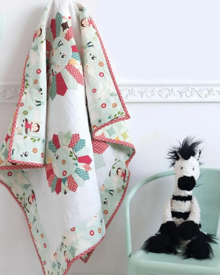 Check out this fantastic and charming Dresden Baby Quilt design! This pattern is made with Dresden blocks with a modern twist, creating a whimsical yet timeless quilt that is perfect for your little ones' nursery. Follow the step-by-step instructions to create a cozy 38&rdquo; x 48&rdquo; personalized quilt that will be a keepsake in your family.