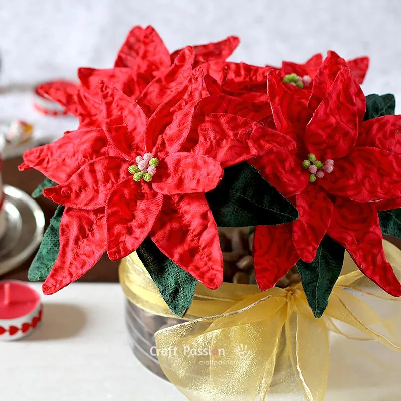 Learn how to make a fabric flower with this simple poinsettia tutorial. Use fabric and wire to create festive Christmas decorations or DIY bouquets.