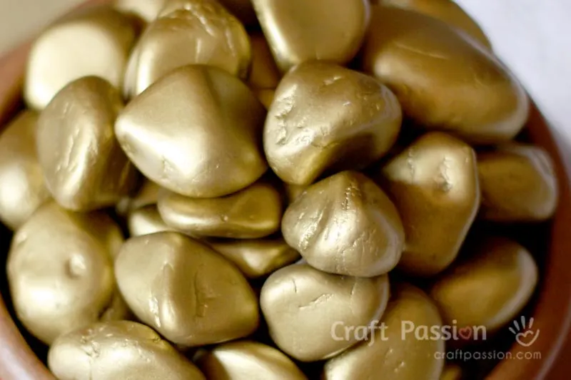 Make this easy faux gold nuggets decor to bring good luck to you. All you need are pebbles and gold spray paint. A pot of gold nuggets is a pot of good luck!