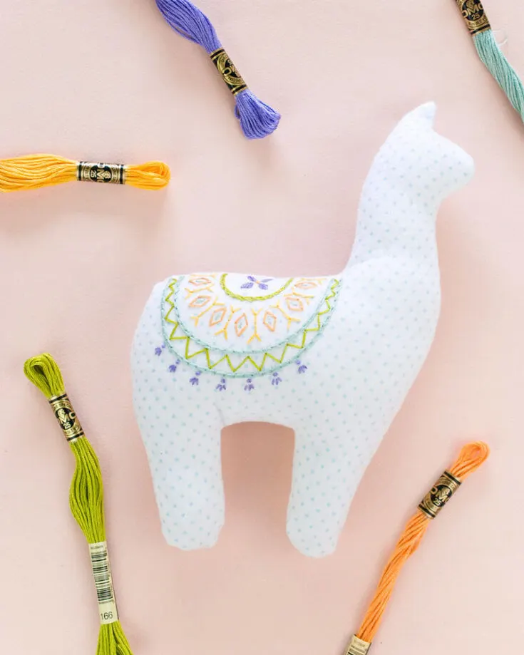 Who says stuffed animals are just for children? This embroidered alpaca has a beautiful pattern on its back that makes it colorful and aesthetically pleasing. Beyond its looks, this is still a cuddly stuffed animal, so this is the perfect addition to any couch or bed.