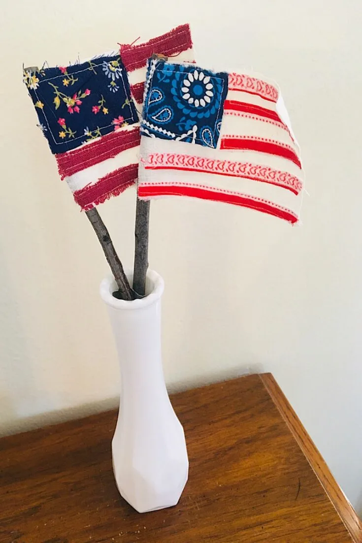 With some creativity, make these scrap fabric flags that can be the center of your table during your next 4th of July party! A great alternative to disposable flags that doesn't even require sewing.