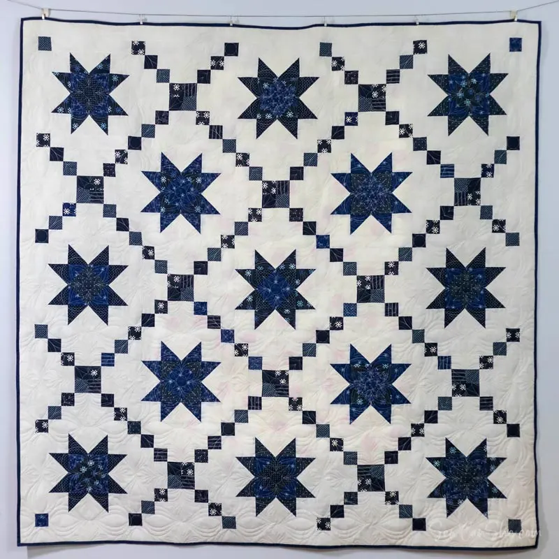Inspired by blue and white Amish quilts, this easy Variable Star Quilt is so breathtaking that it's a must-have on your quilt list! It features a traditional quilt block technique that is quite popular in the quilting world, and it consists of 13-star blocks and 12 Irish chain blocks that result in a classic-looking quilt. The finished size of this stash-buster project is 76" x 76" throw.&nbsp;