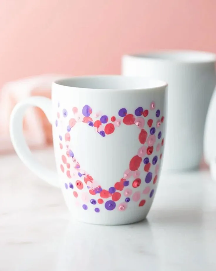 Here is another variation if you want to revamp your mugs at home. All you would need to do is grab your paint of choice, with several colors, and dip your fingers in them to stamp on the mugs. It is a fun and creative way to personalize her mugs and a great way to give mom a cup of love.
