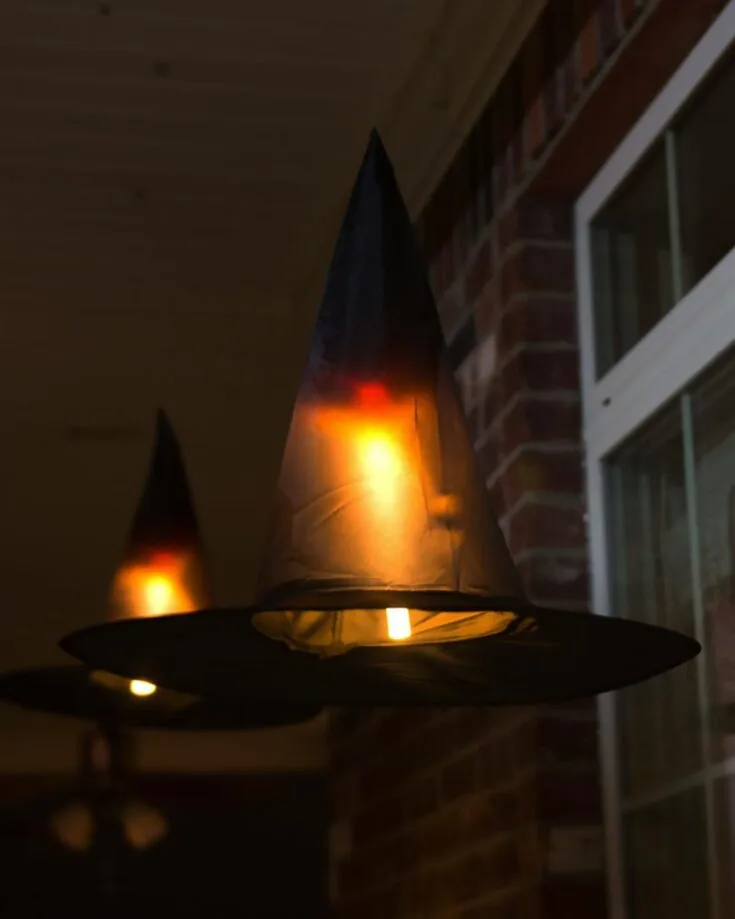 Try out these DIY Halloween decorations called the Floating Witch Hats! Create multiple of them to symbolize a horde of witches on your front porch. They add such an eerie feeling, and we approve of it!